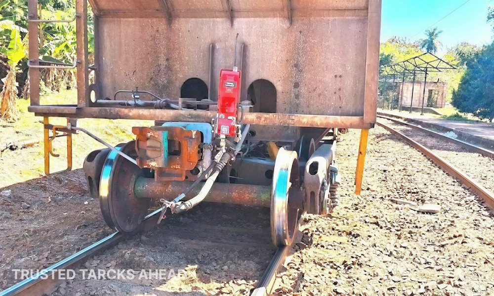 Intertech Rail end-of-train device on the last freight car of a train moving away along a straight railway line