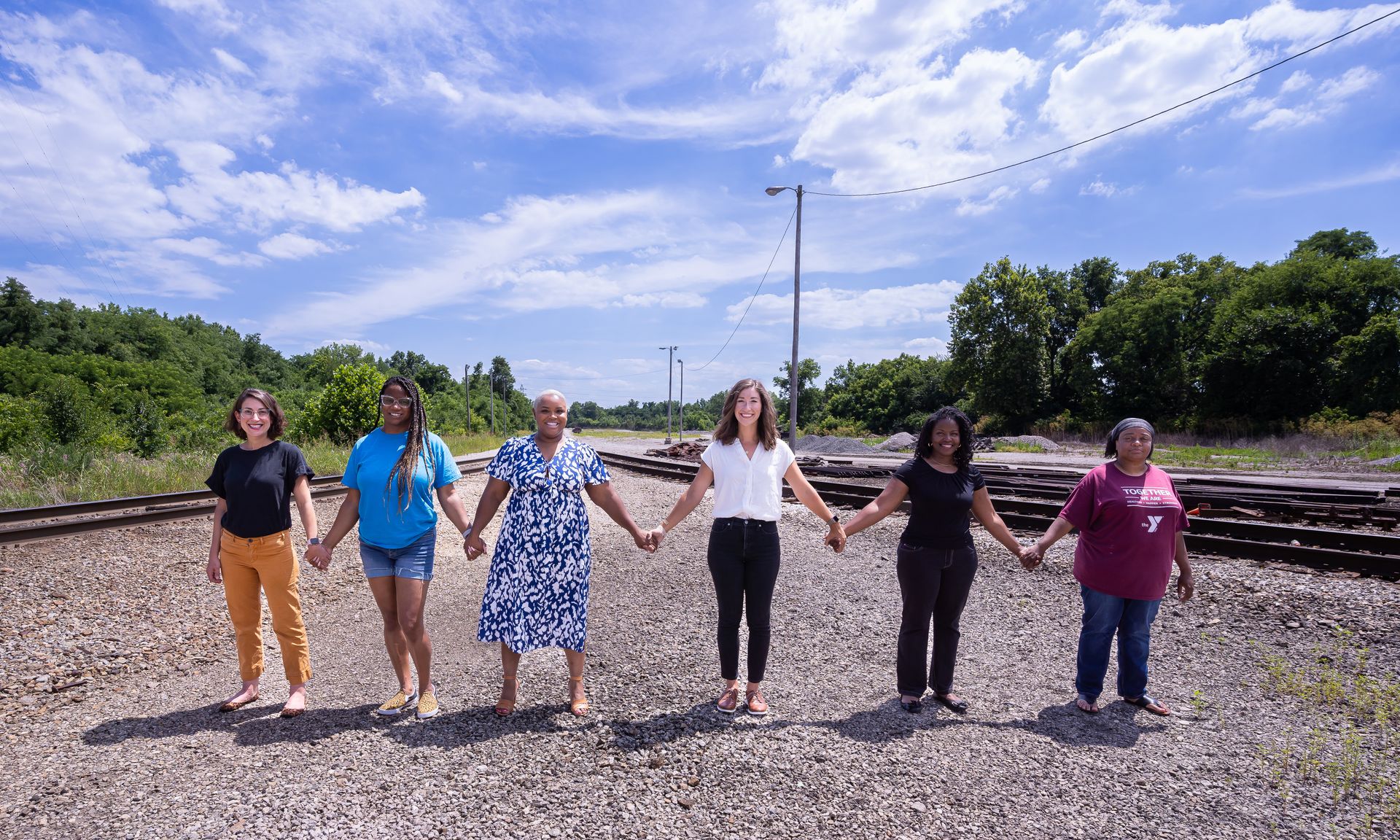 Group photo of Air Justice leaders standing side by side holding hands