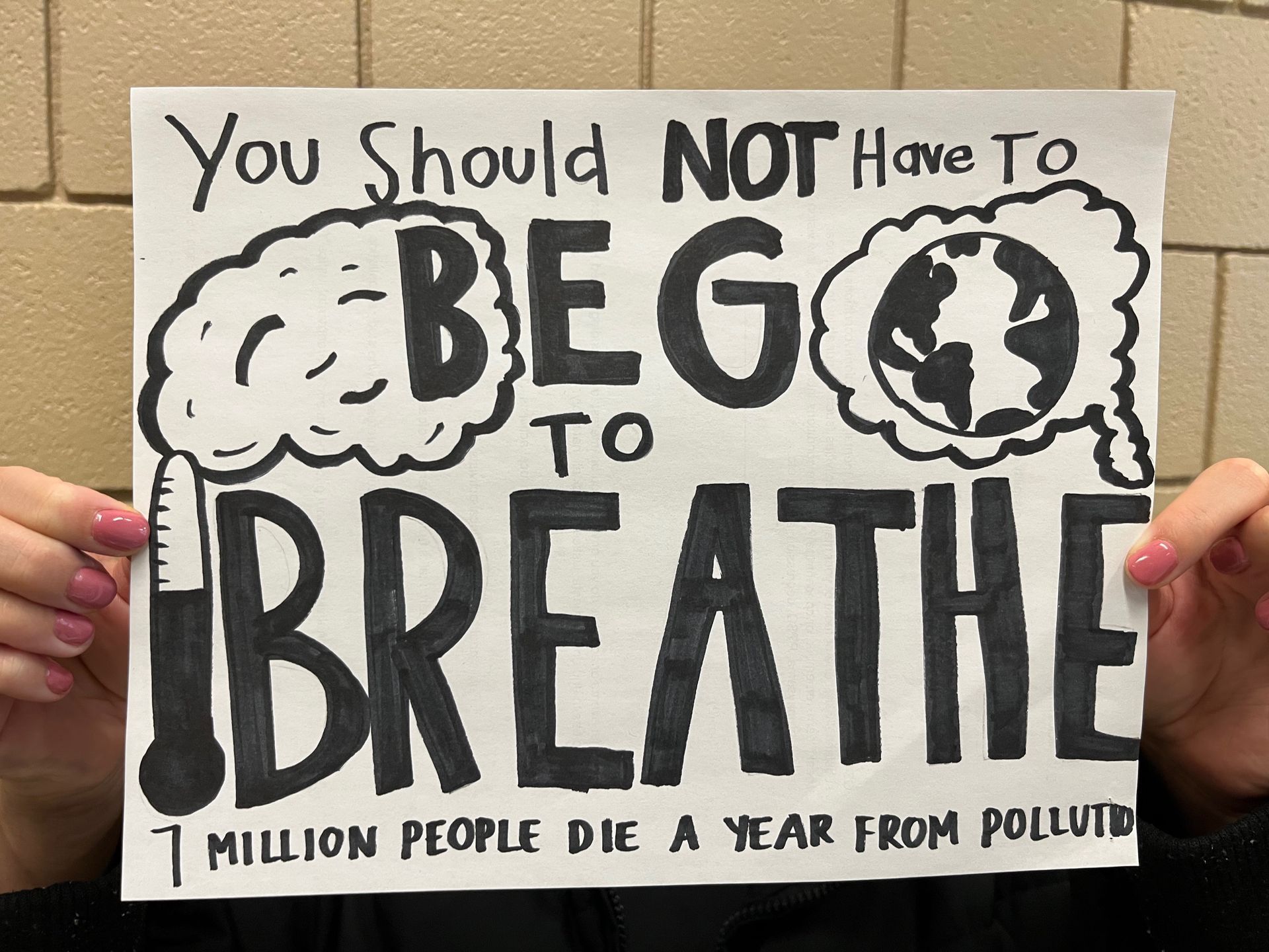 Student sign in black and white that reads 