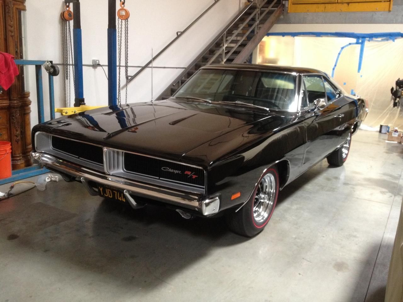 A black car is parked in a garage