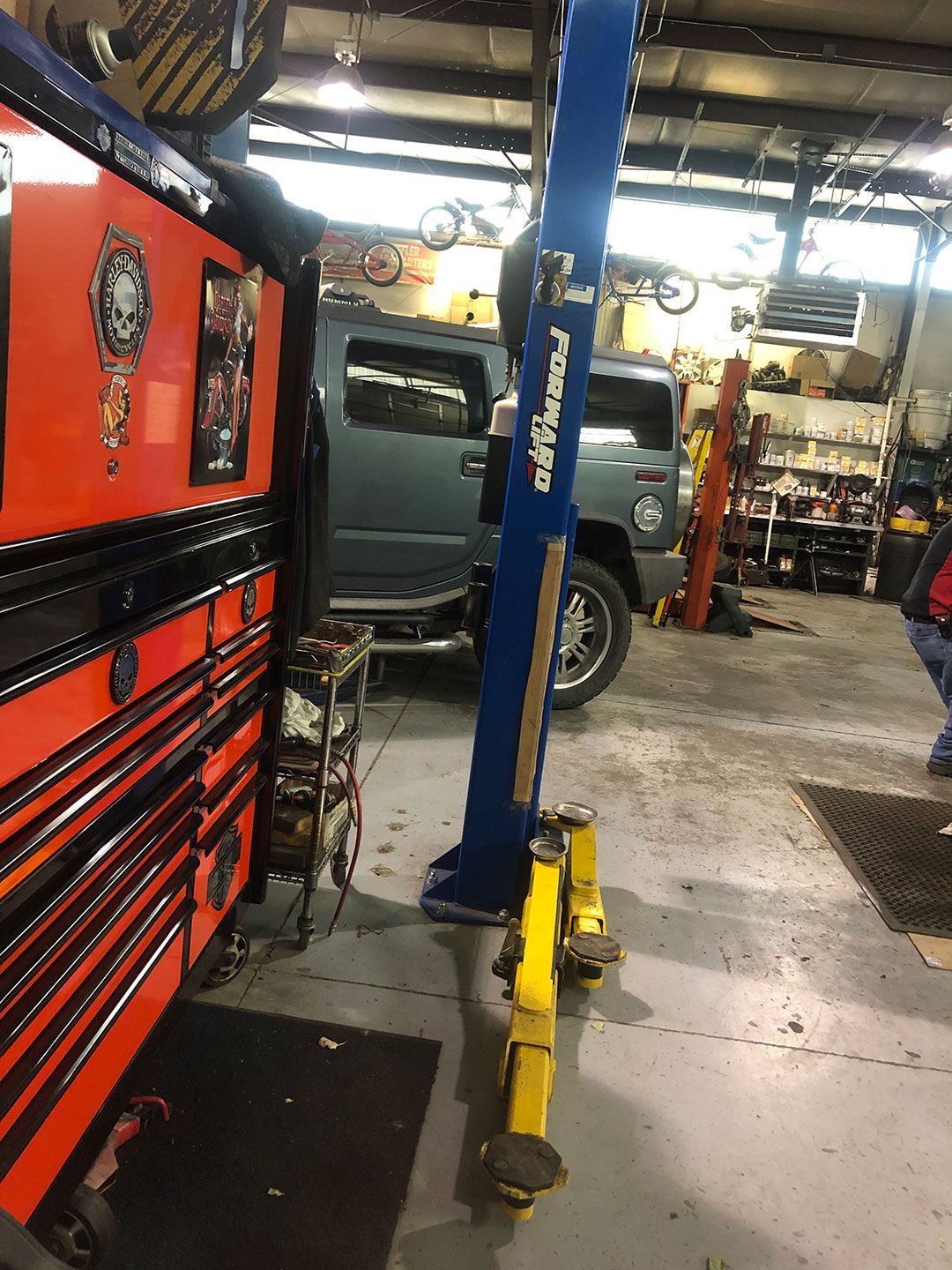A car is sitting on a lift in a garage.