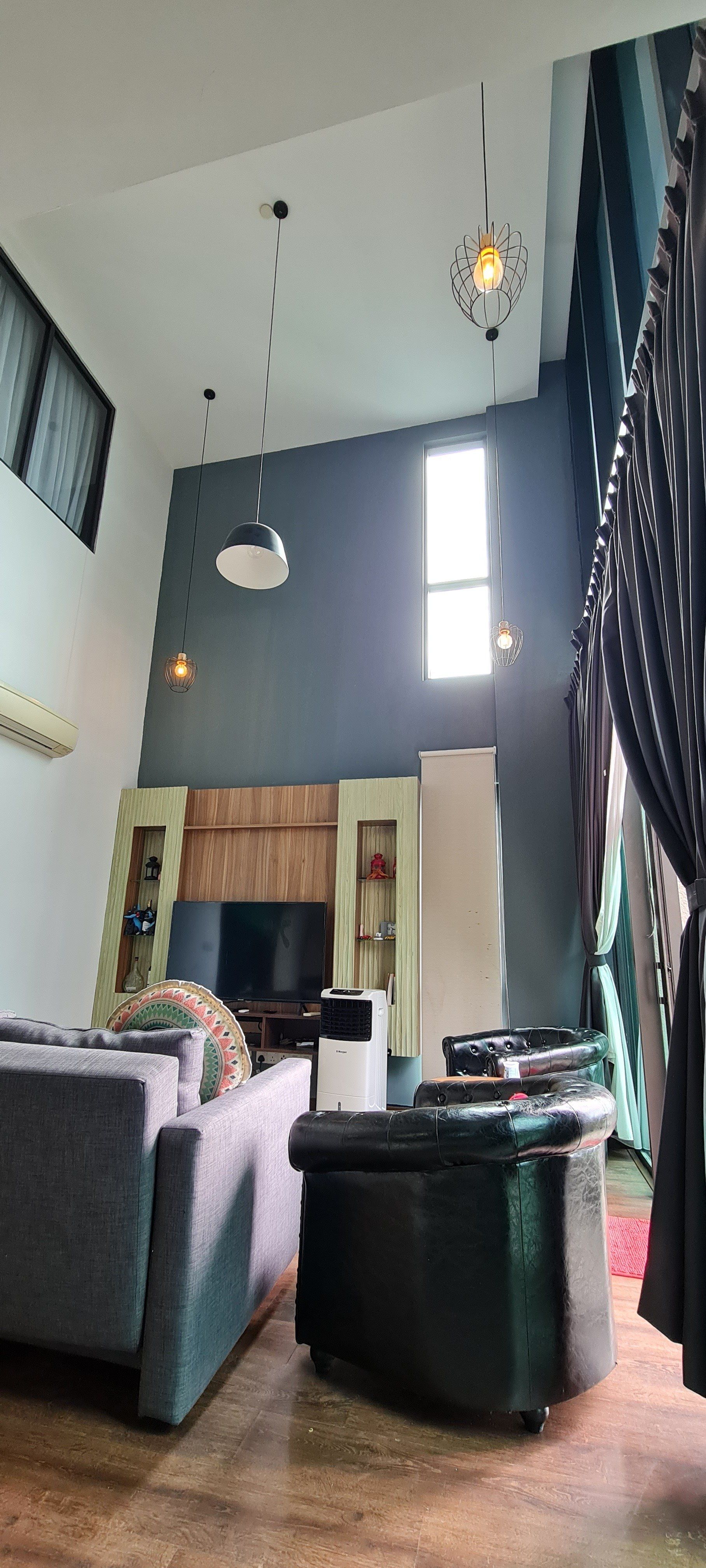 A living room with a couch , chairs , and a television.