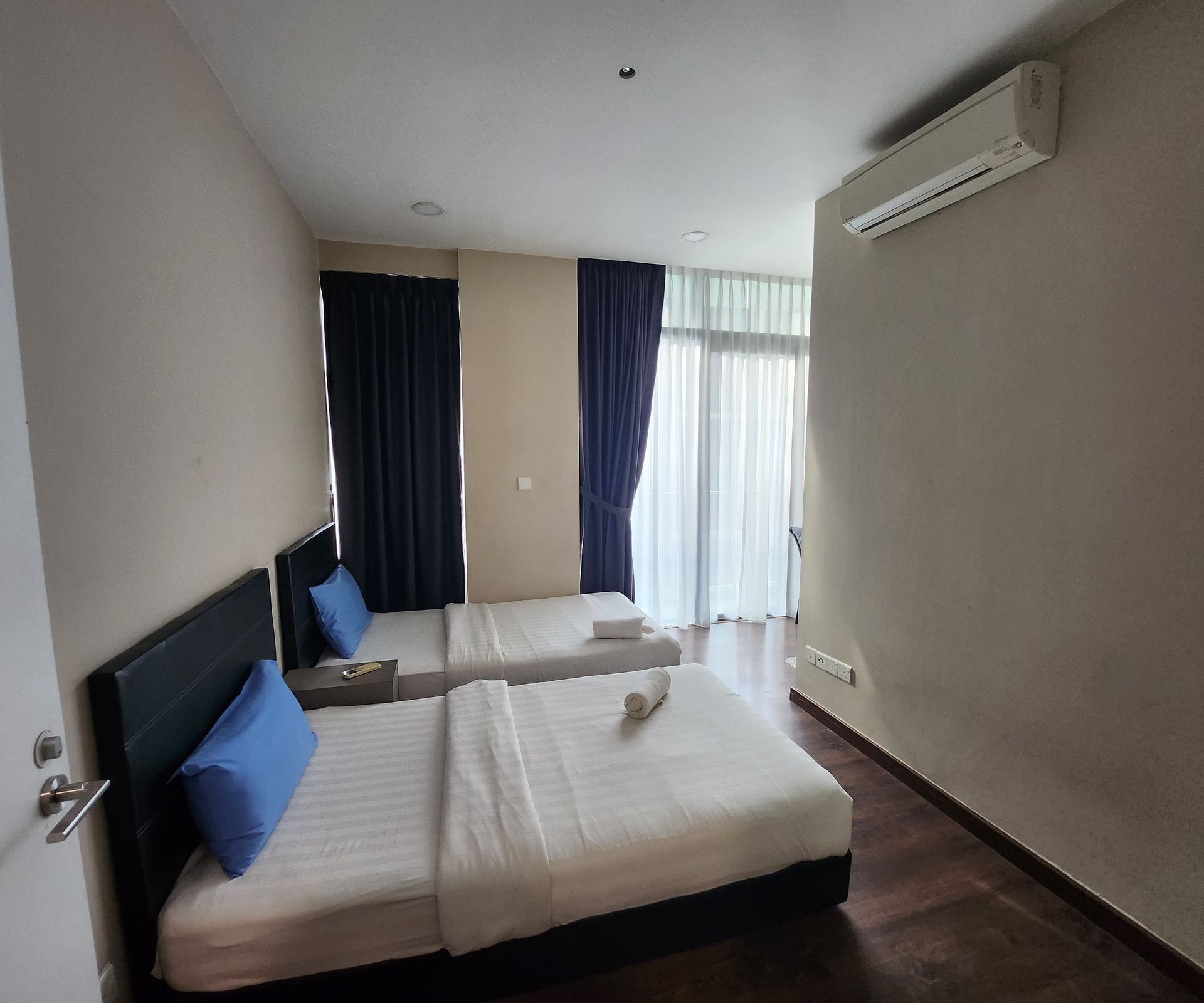 A hotel room with two beds and a window