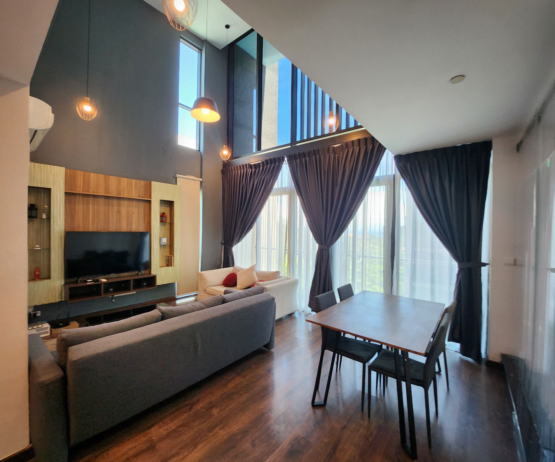 A living room with a couch , table and chairs.