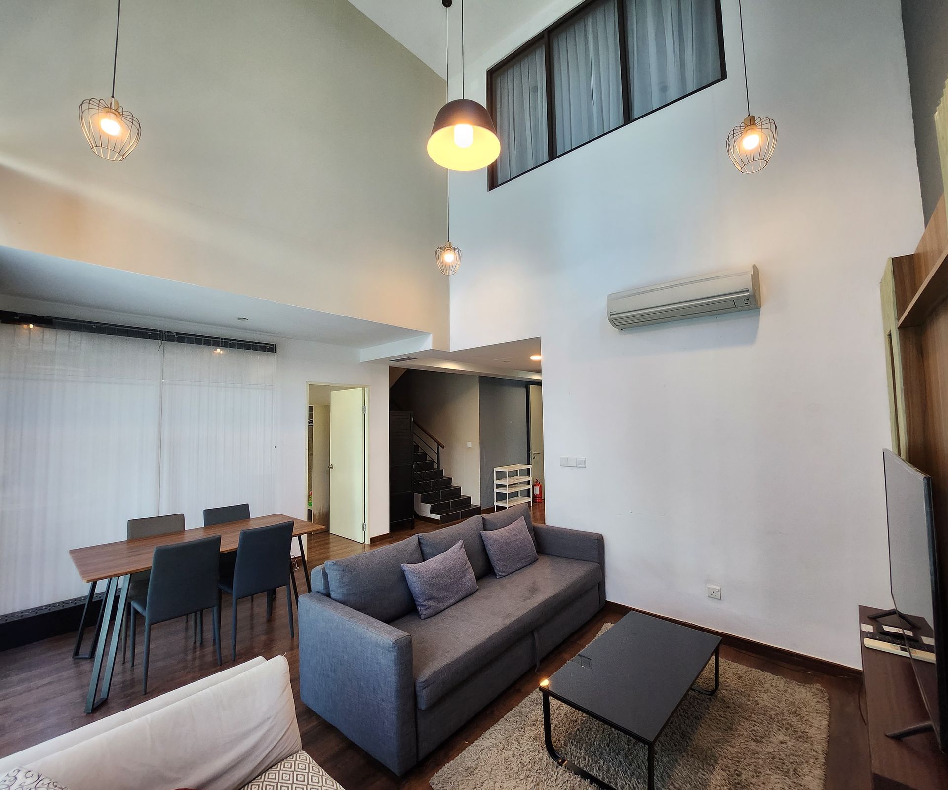 A living room with a couch , table and chairs