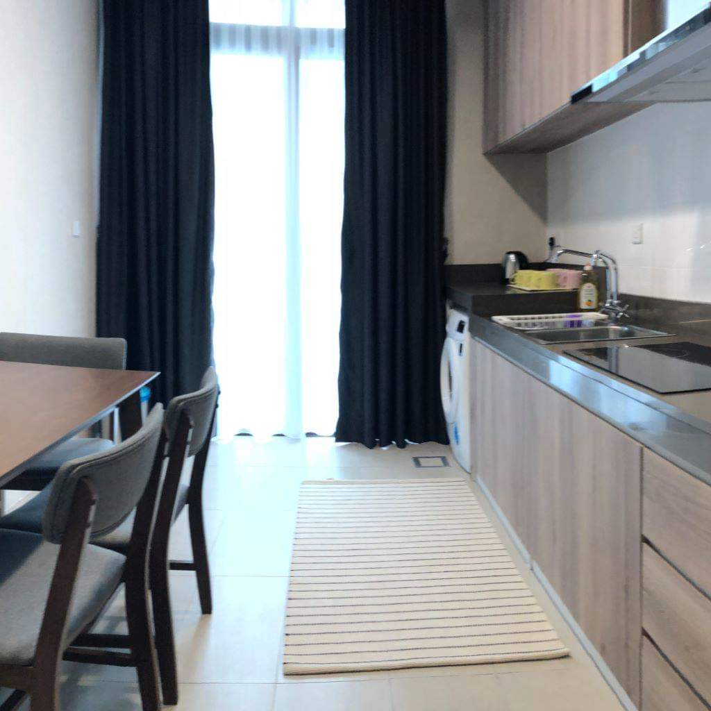 A kitchen with a table and chairs in it
