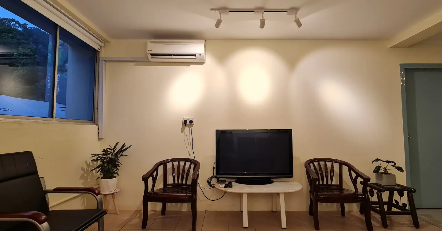 A waiting room with chairs and a flat screen tv