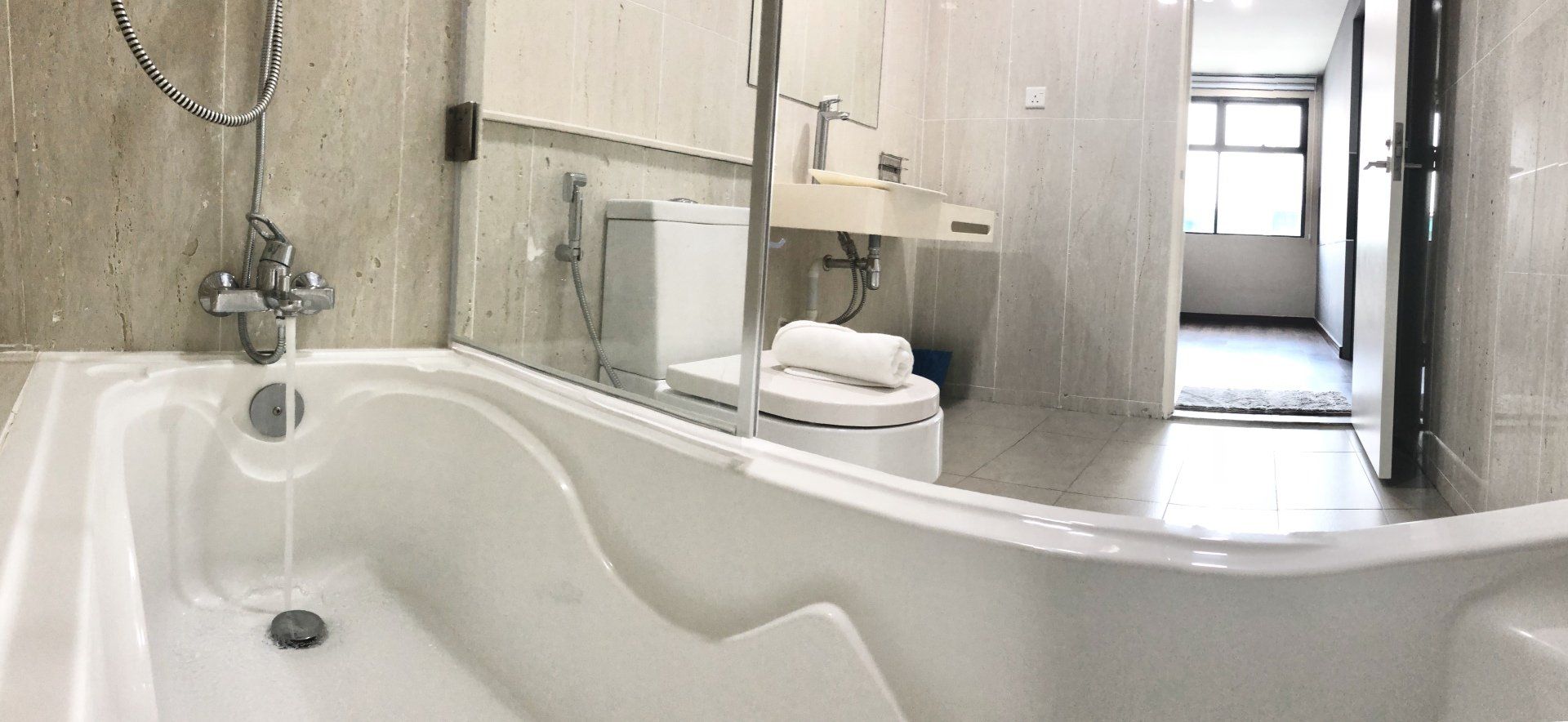A bathroom with a bathtub , toilet , sink and mirror.