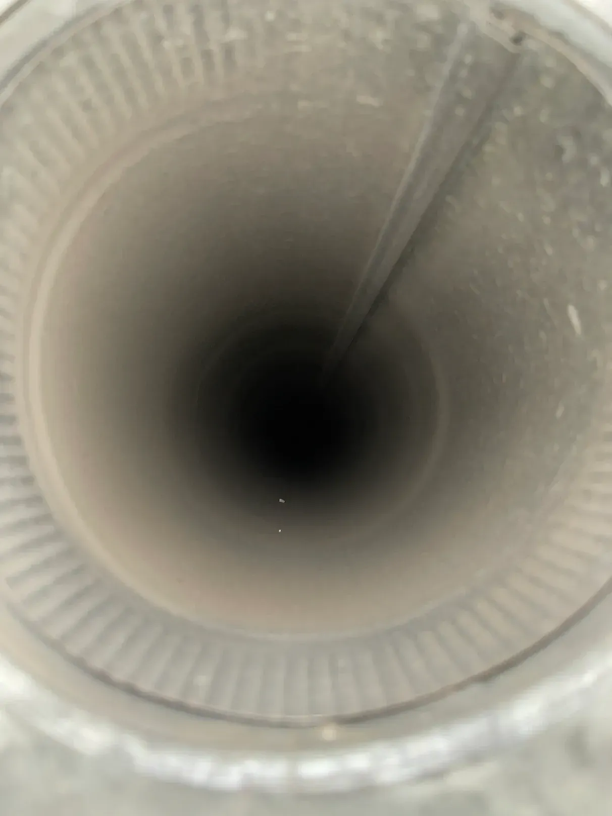 A close up of the inside of a duct with a hole in the middle.