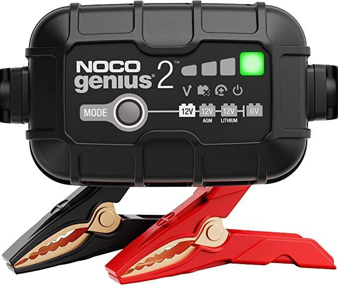 A noco genius 2 battery charger with red and gold clamps