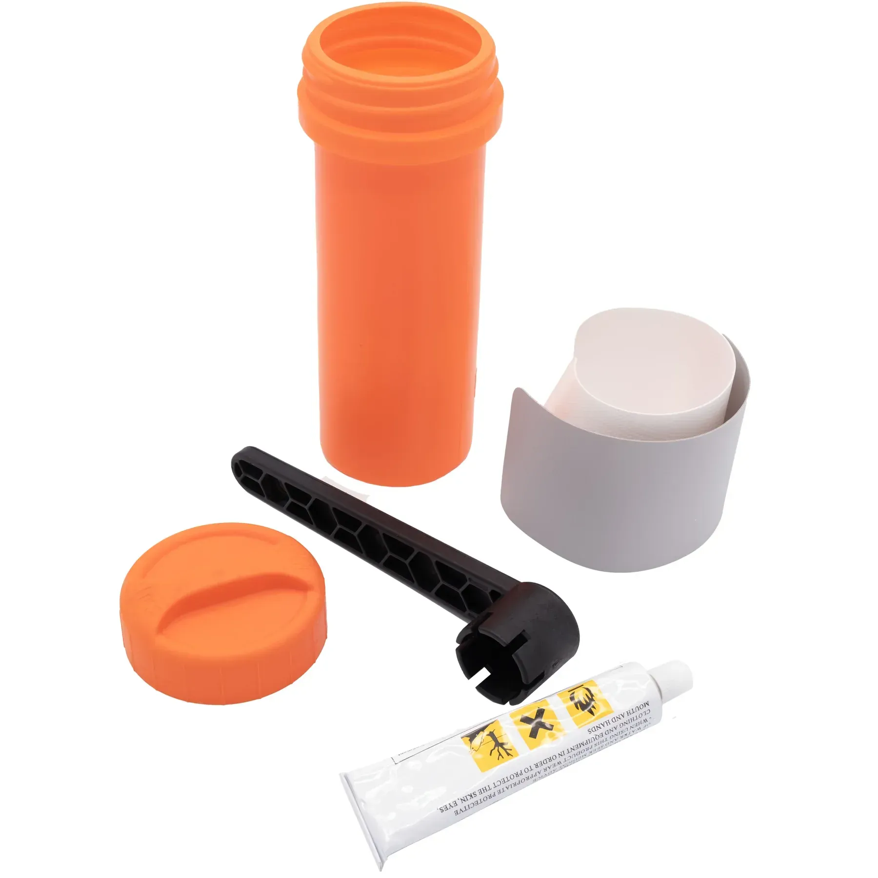 An orange container with a tube of glue and a wrench