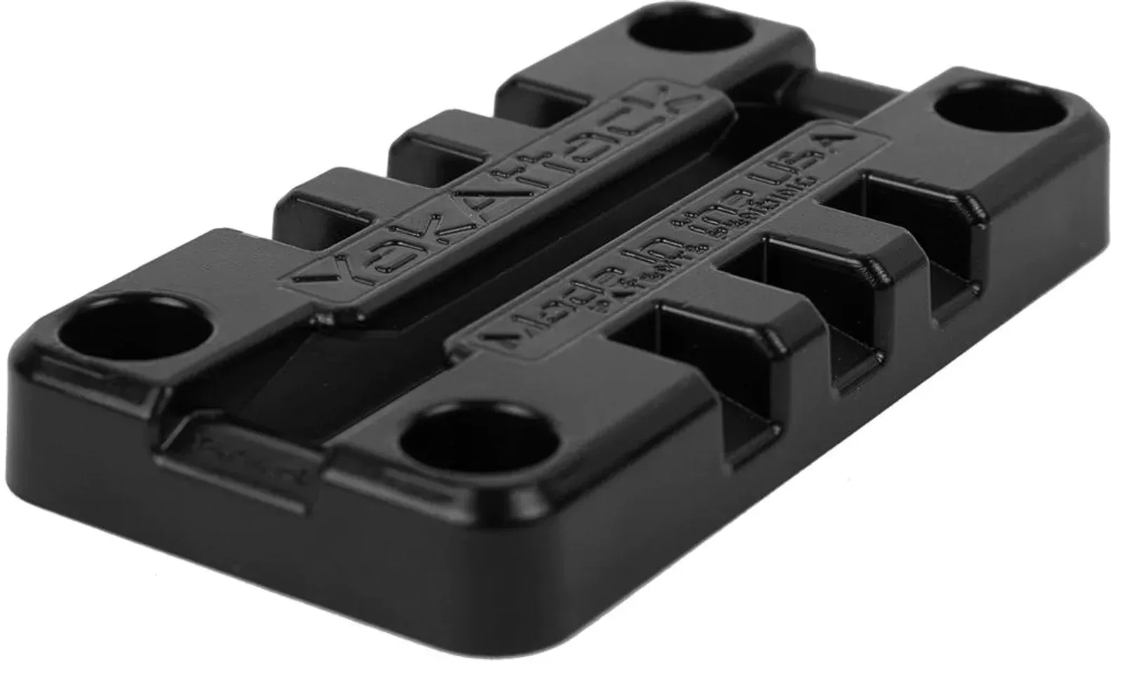 A black plastic block with holes in it on a white background.