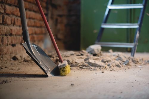 A Shovel And A Broom Are Sitting On The Floor Next To A Ladder - Fairbanks, AK - Xpert Cleaning, LLC