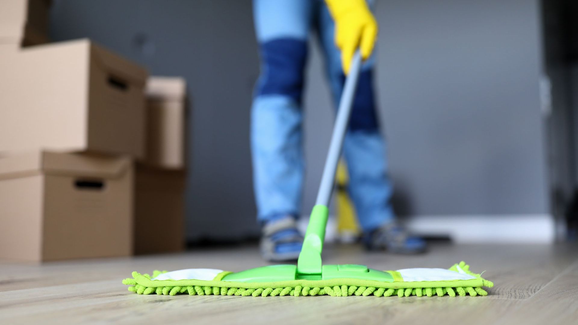 A person is cleaning the floor with a mop.