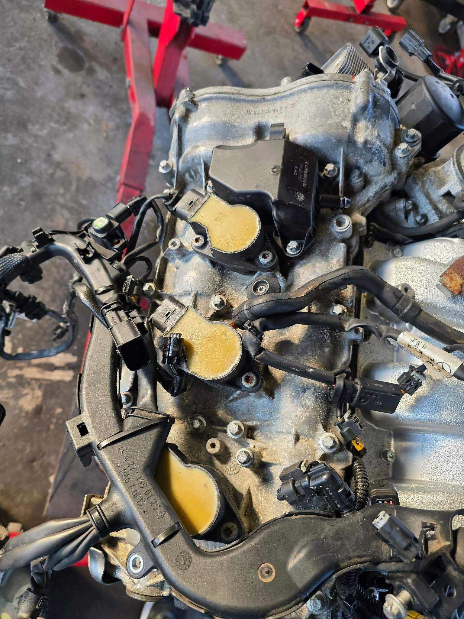 Engine with ignition coils attached, viewed from above, in a repair setting. | Seth's Auto Care
