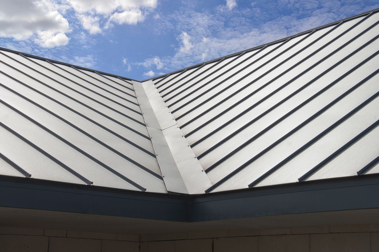 A close up of a roof with a blue sky in the background.