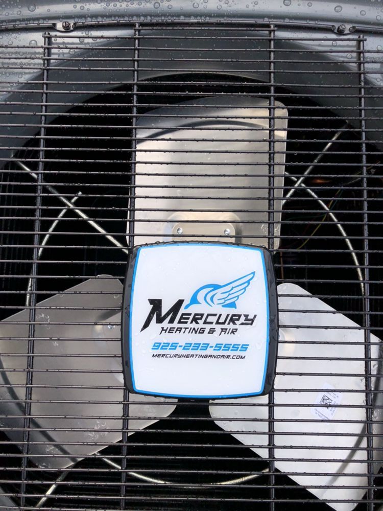 Large industrial fan with a Mercury logo on the center hub behind a metal grille.