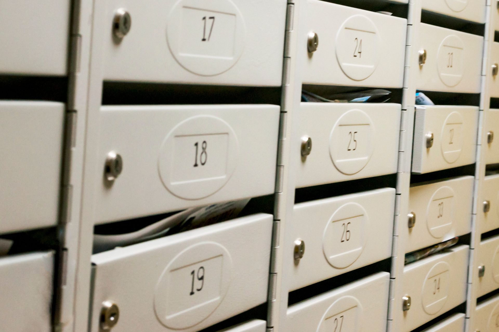 A row of mailboxes with the numbers 18 19 and 20 on them