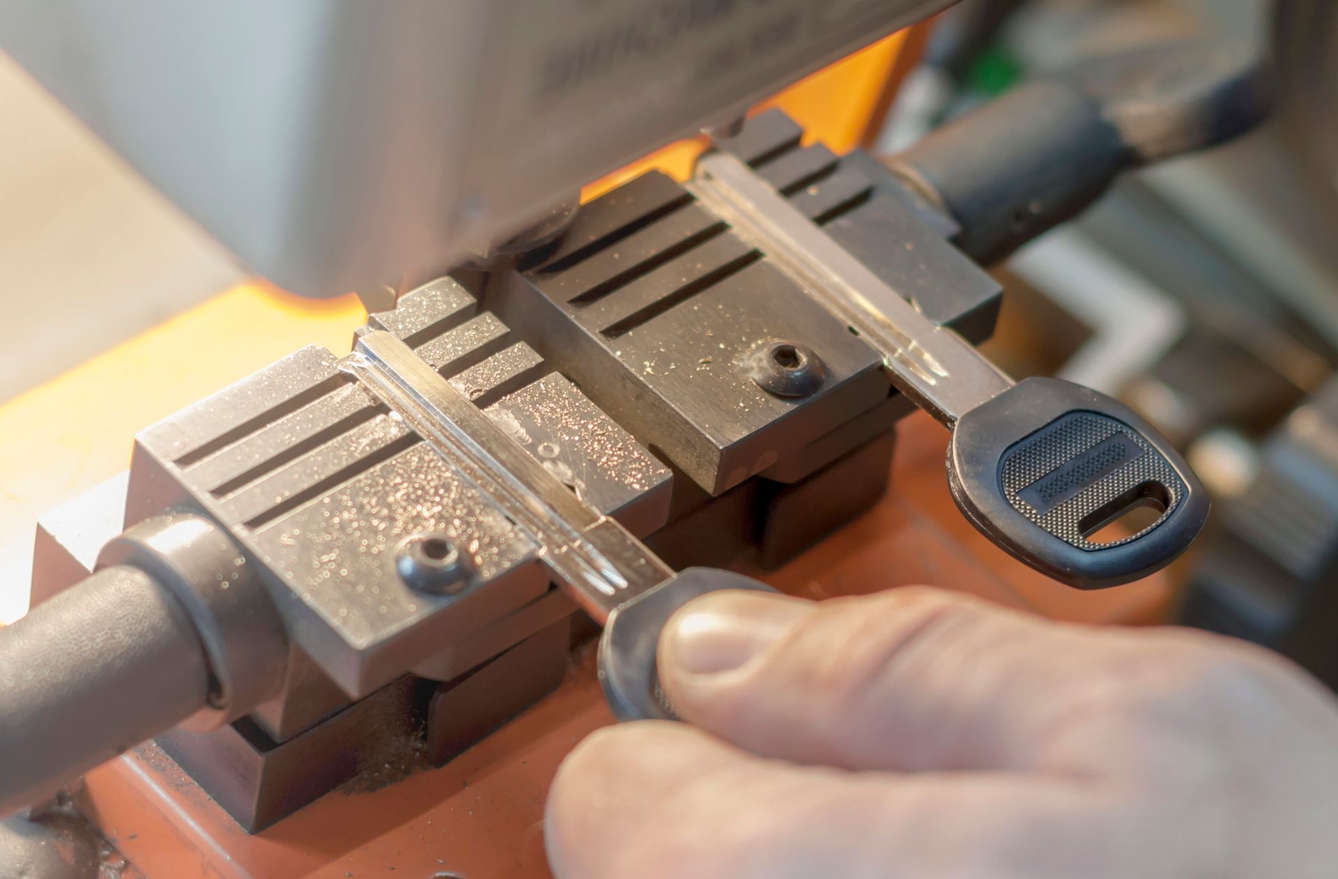 A person is cutting a key with a machine.