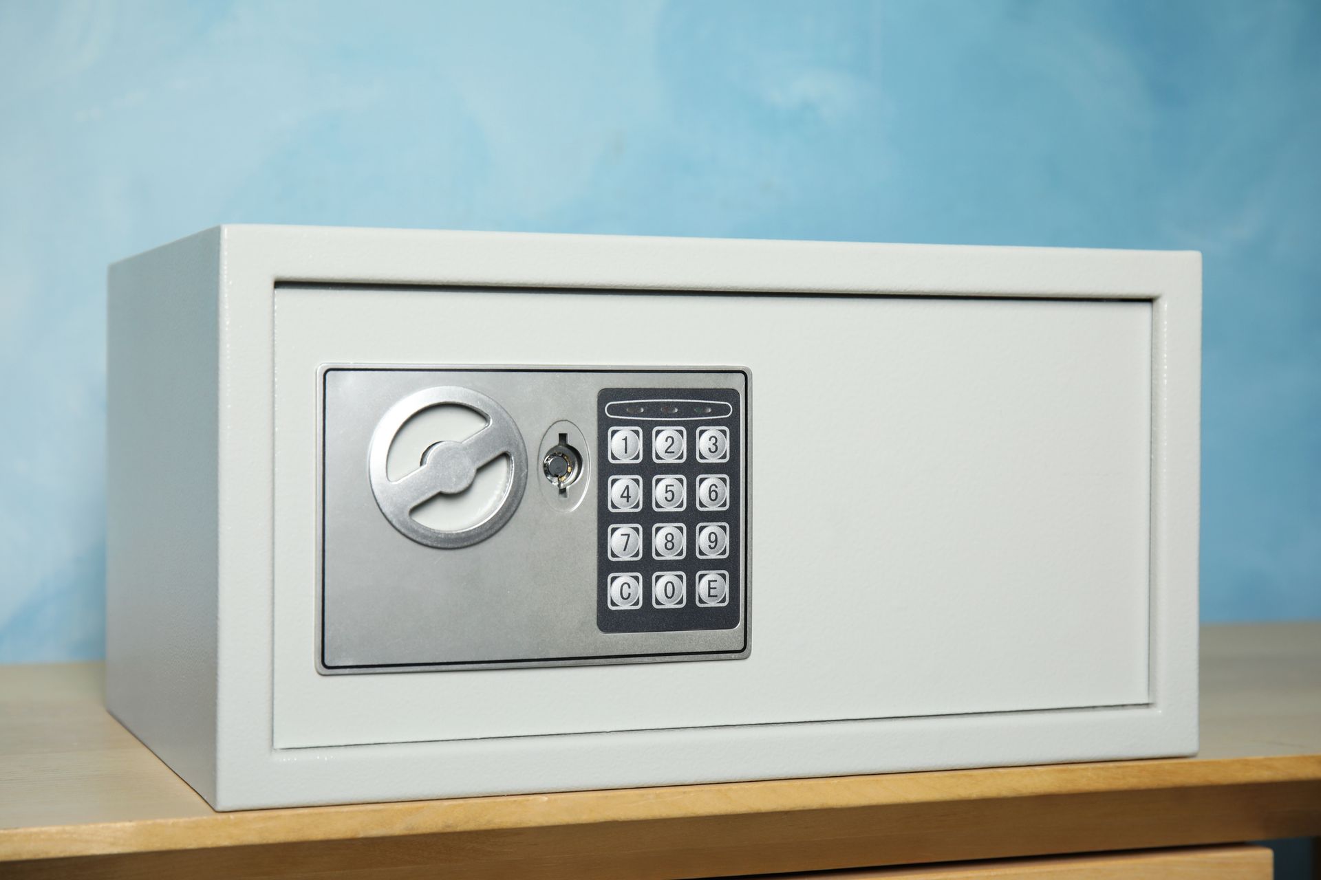 A digital safe is sitting on top of a wooden table.