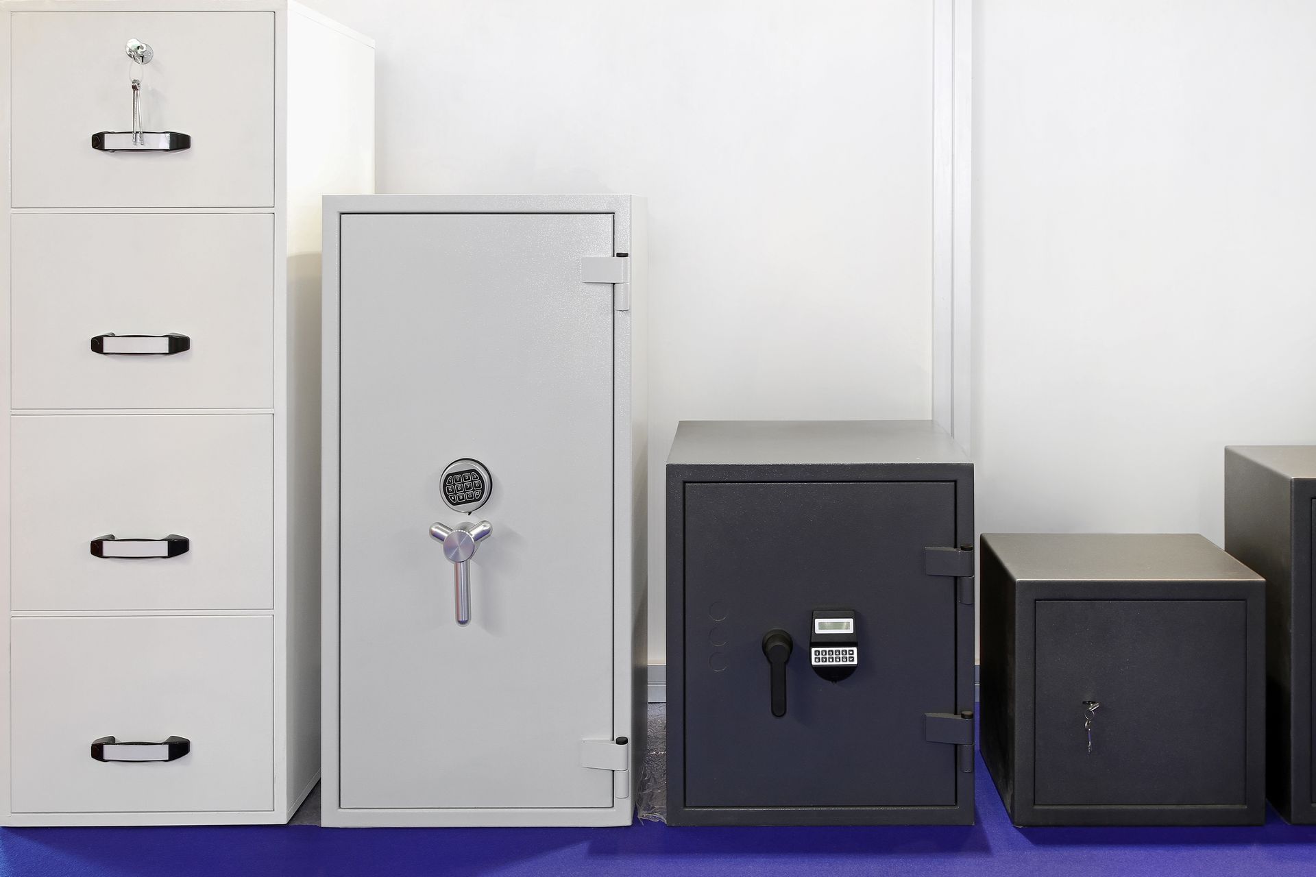 A group of safes are sitting next to each other in a room.