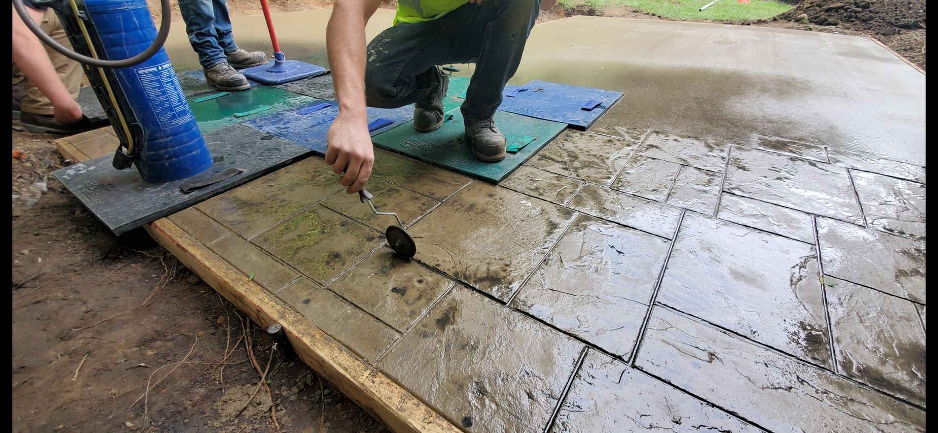 Decorative concrete with color and stamp texture to mimic look of pavers.