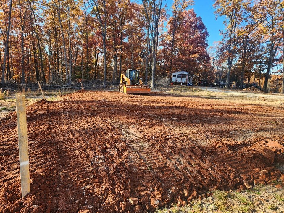 rough cuts construction out of Harrison, Arkansas grading land in preparation for building