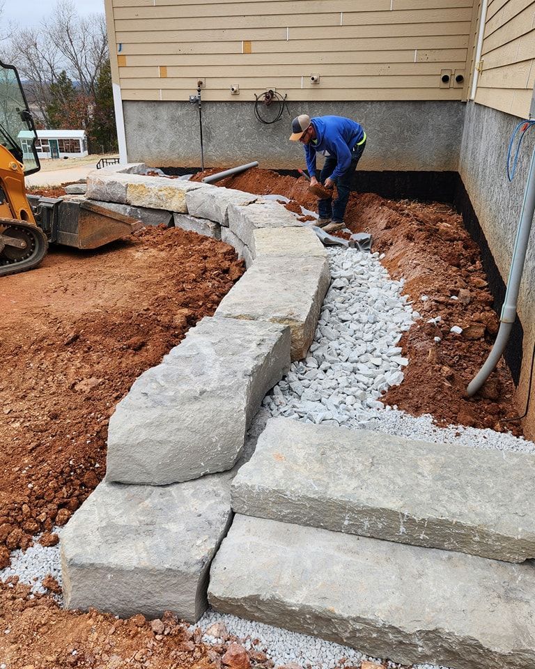 Retaining wall installation of limestone stones for sitting wall