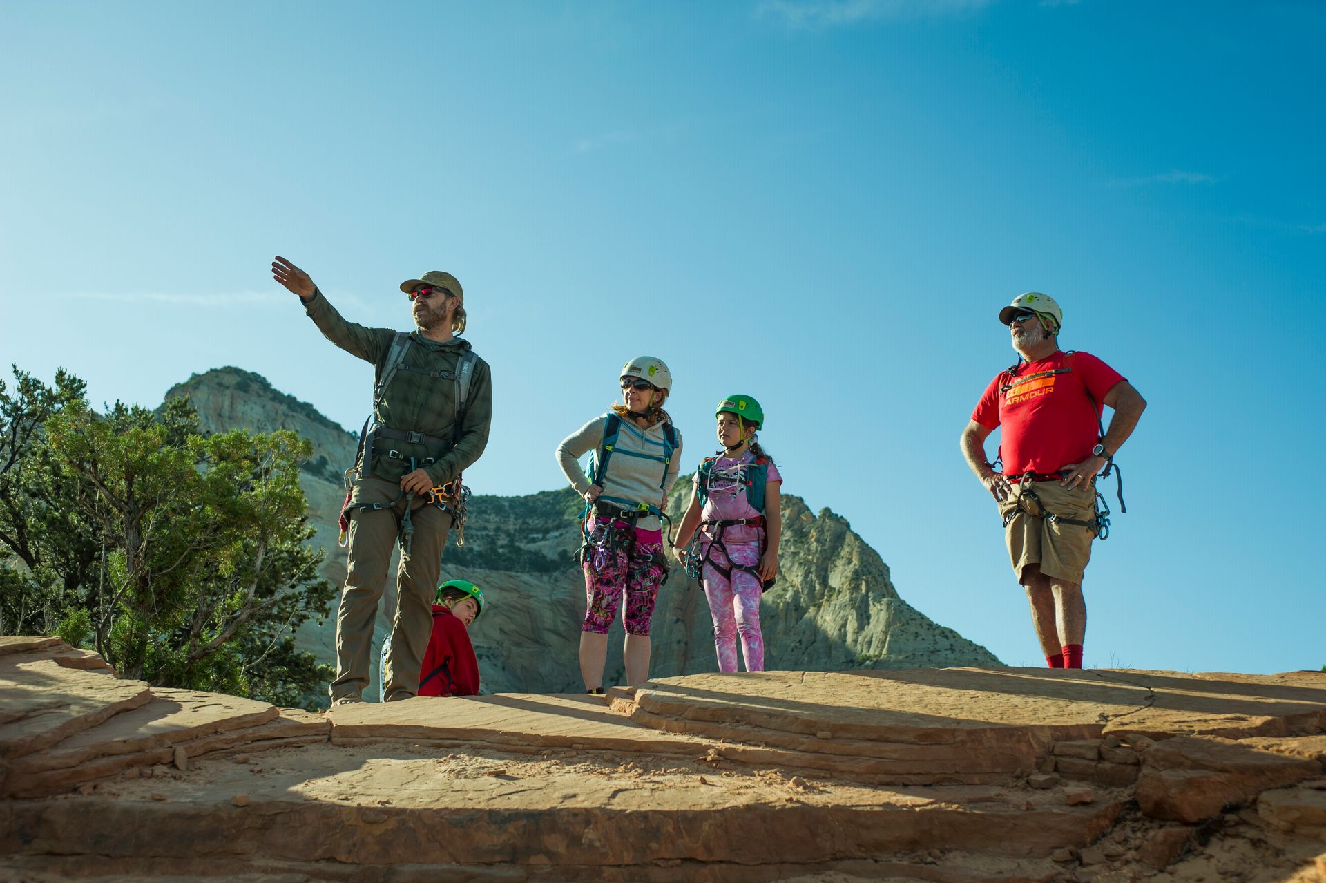 Family walking at the mountain with tour guide