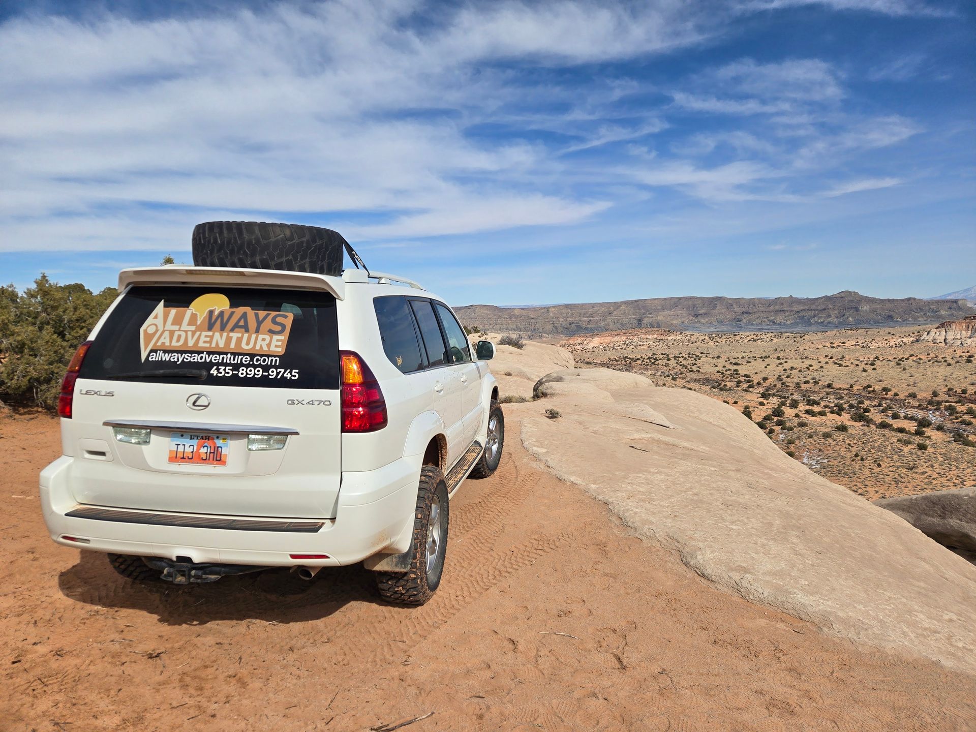 White SUV on a rocky trail with