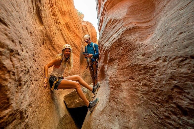 Woman enjoying canyoneering with tour guide