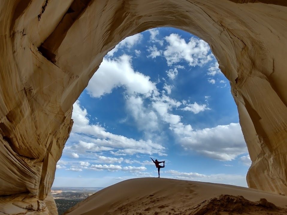 A man is standing in the middle of a canyon.