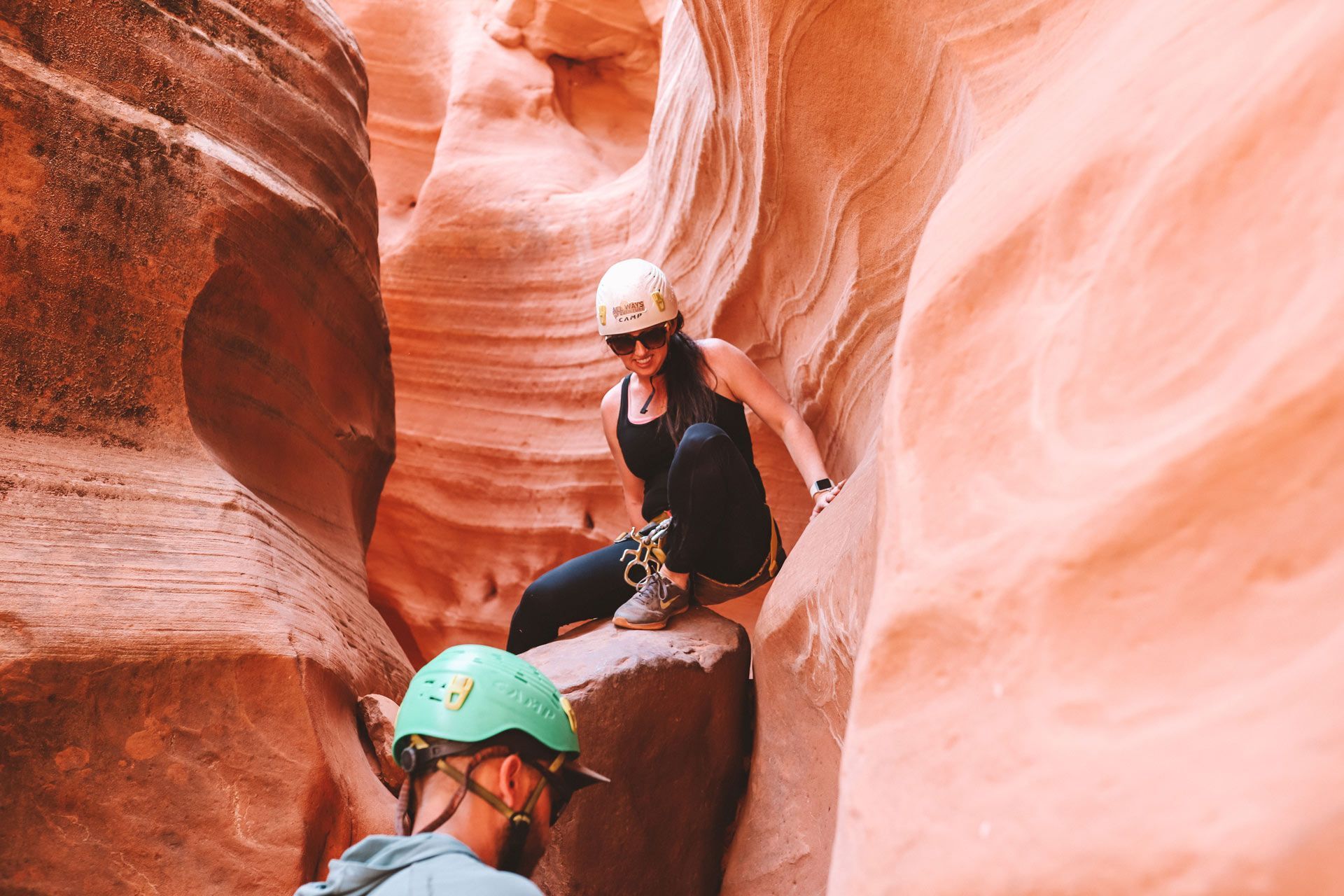 A young boy is hanging from a rope in a canyon