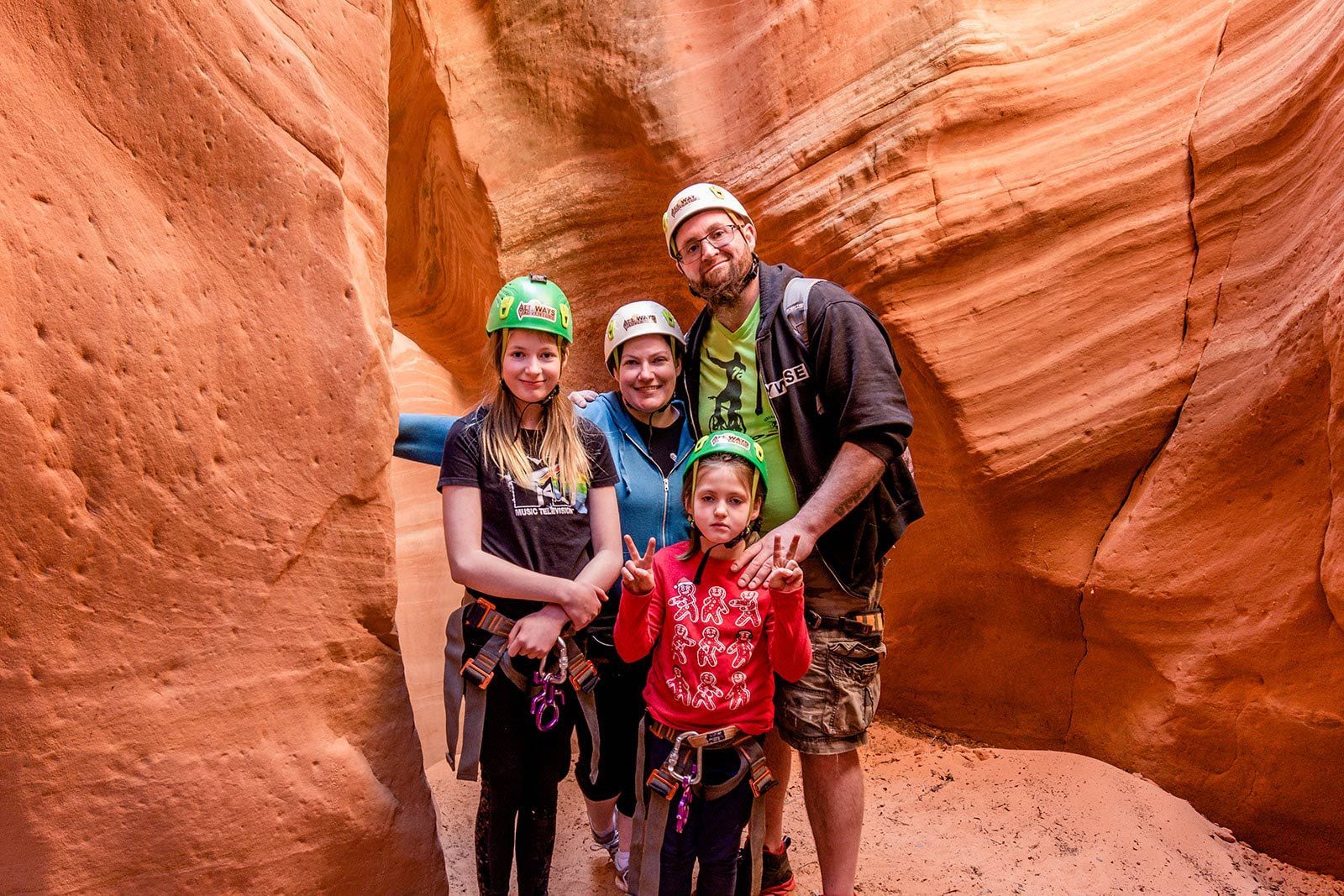Photo of a happy family wearing safety gear in canyon