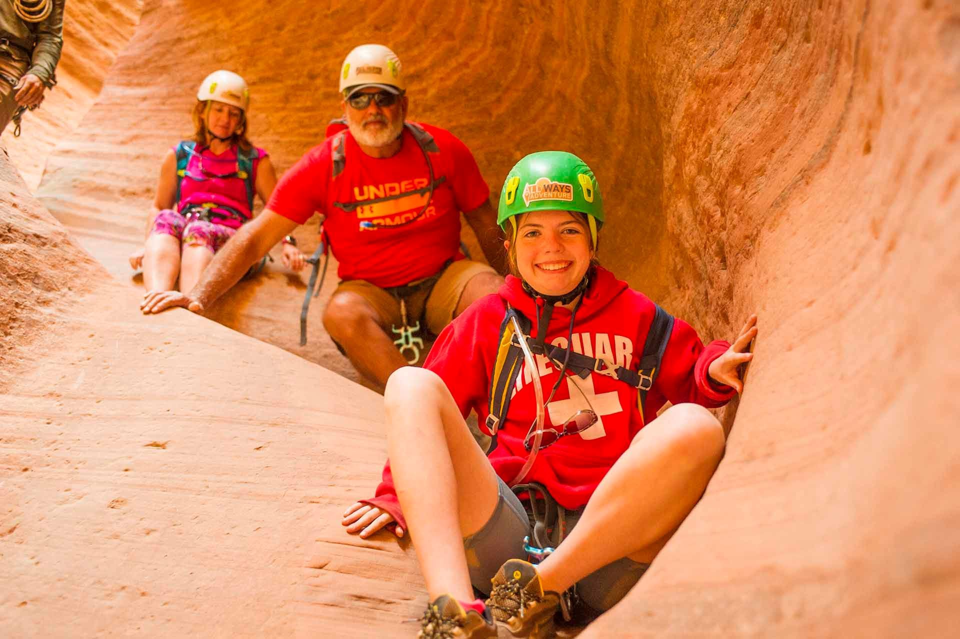 Family enjoying sitting on the side of a canyon