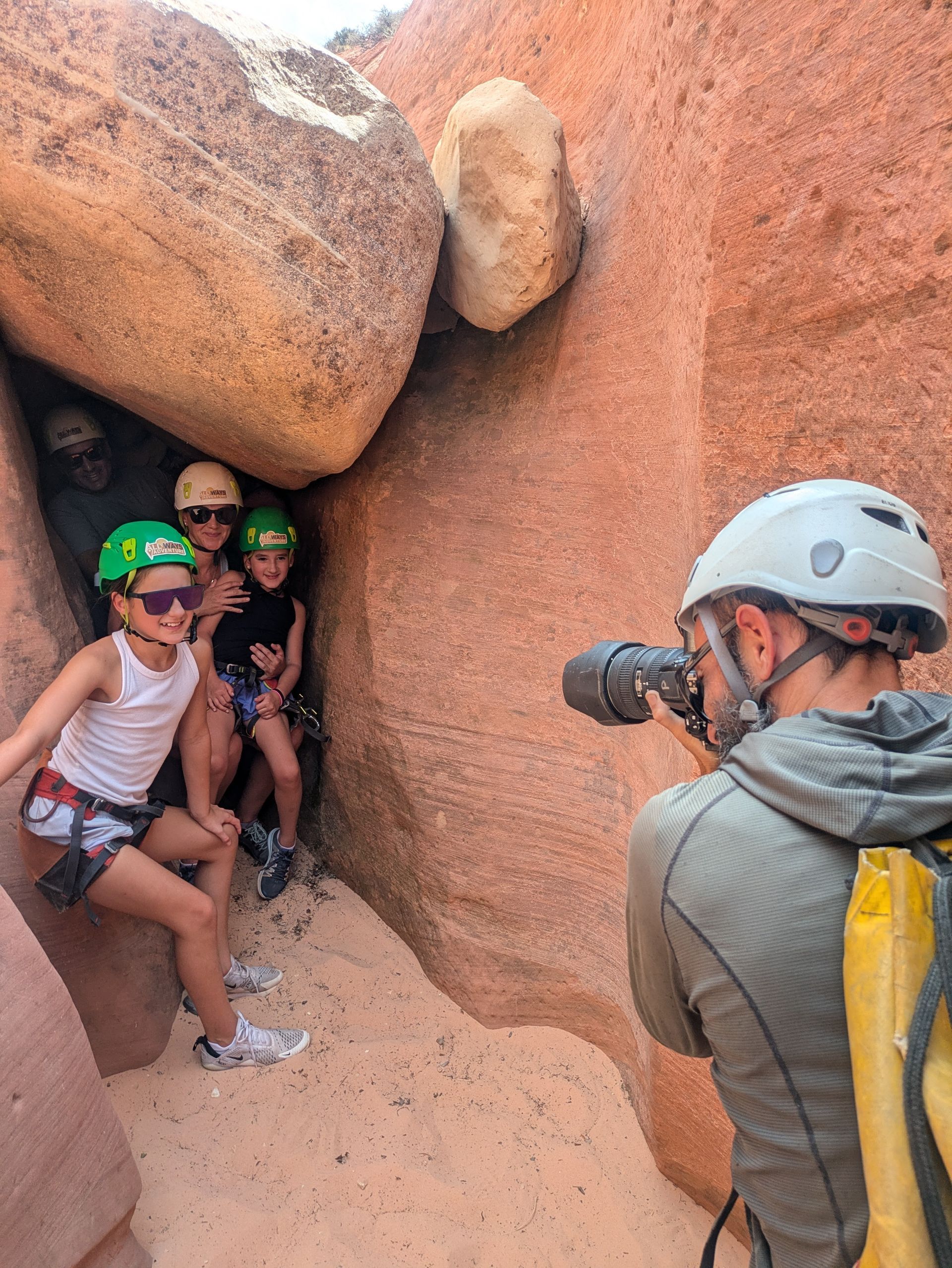 a group of people in zion national park getting their photos taken