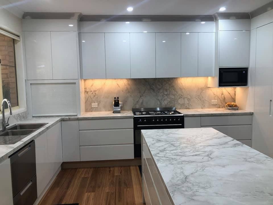 A Kitchen With White Cabinets And Marble Counter Tops — Lake Macquarie Designer Kitchens In Newcastle, NSW