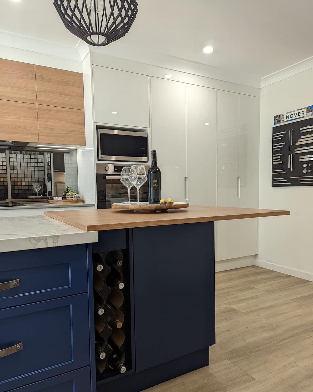 A Kitchen With Blue Cabinets — Lake Macquarie Designer Kitchens In Buttaba, NSW