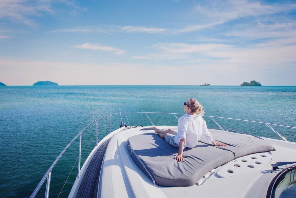 woman overlooking nature on yacht is protected by boat and watercraft insurance