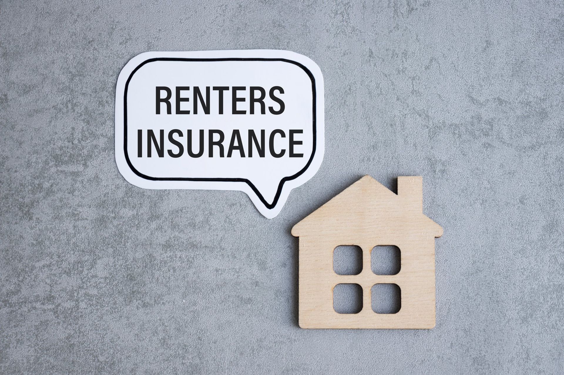 wooden house with speech bubble reading renters insurance