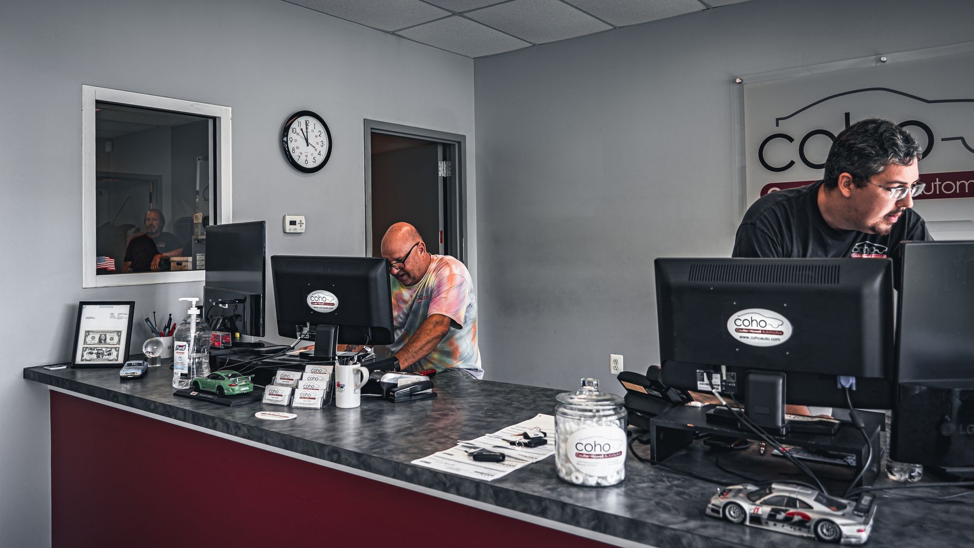 Auto Repair Near Me: Two men are working at a counter at CoHo auto repair shop.
