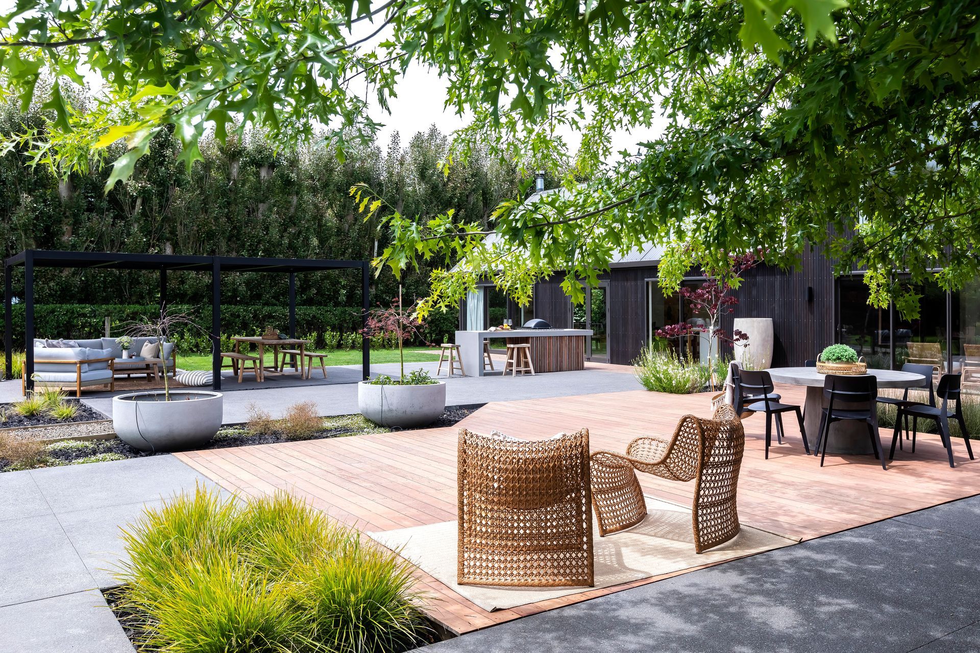 A patio with a table and chairs under a tree