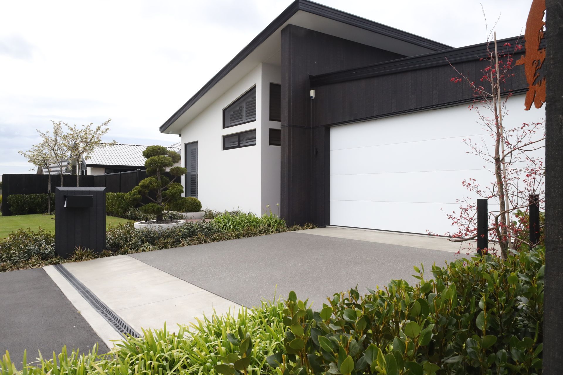 A black and white house with a white garage door
