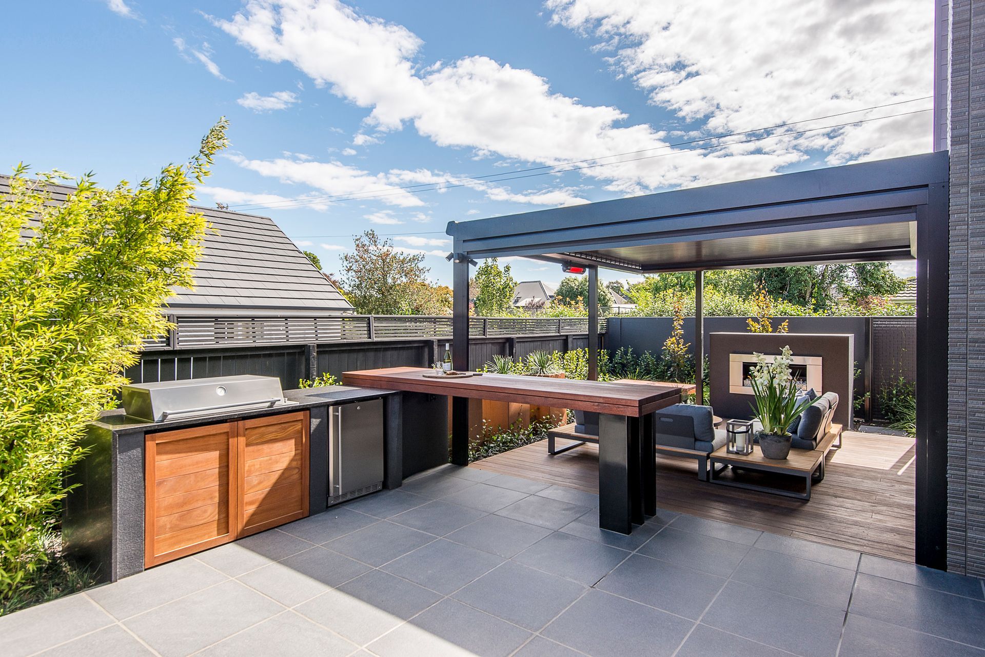 A patio with a table and chairs under a canopy.
