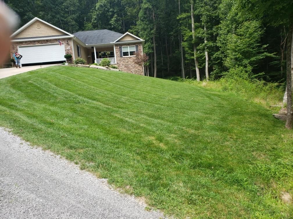 A house with a lush green lawn in front of it