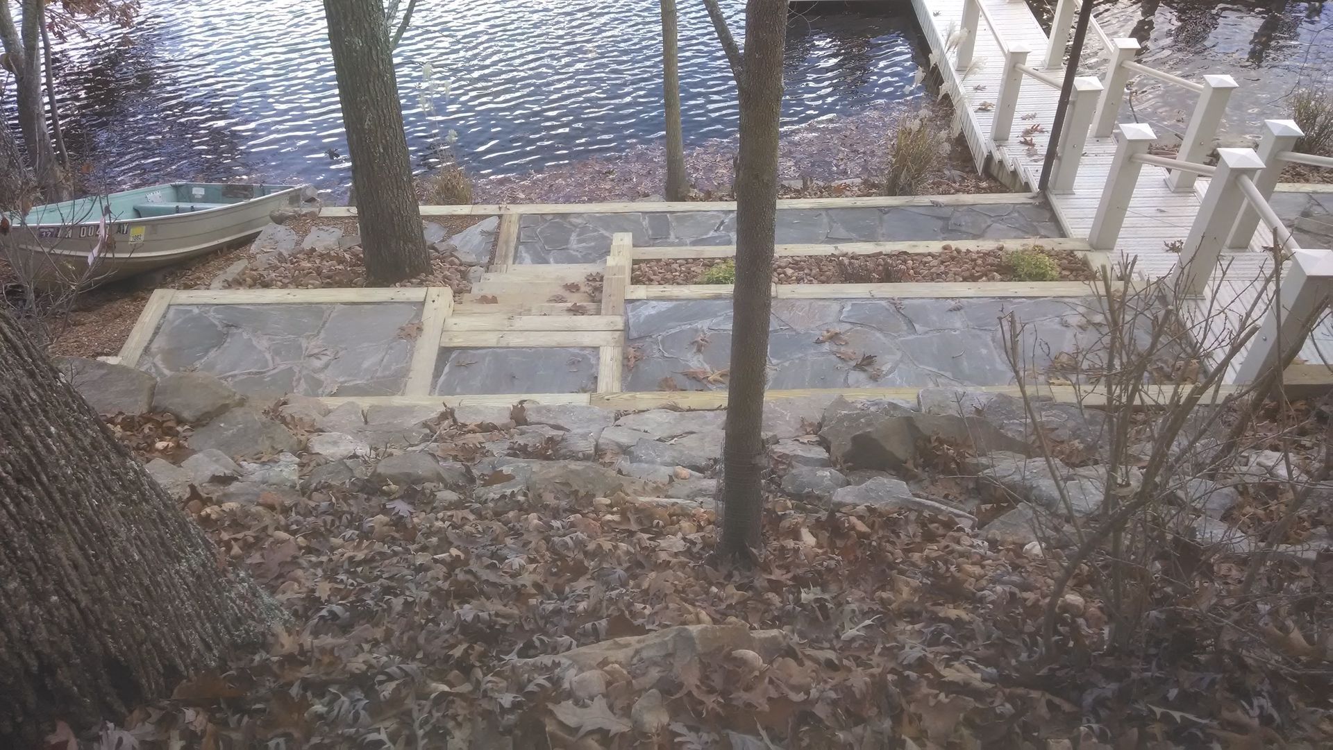 Stairs leading up to a dock with a boat in the background