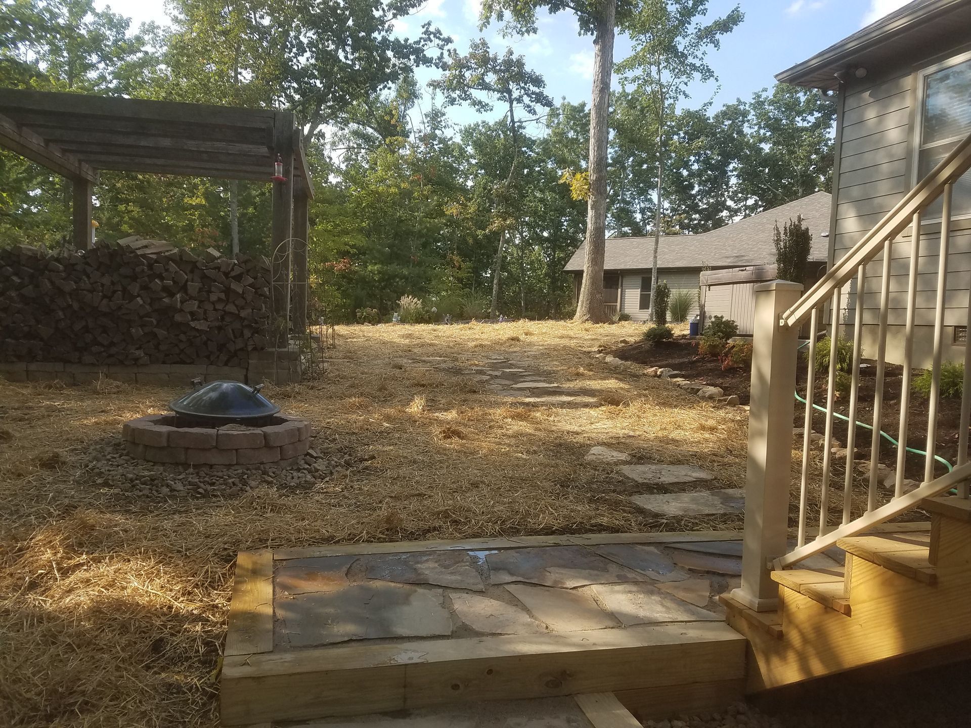 A staircase leading up to a house with trees in the background