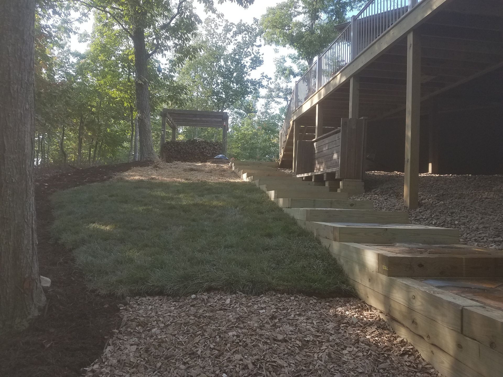 Stairs leading up to a deck with trees in the background