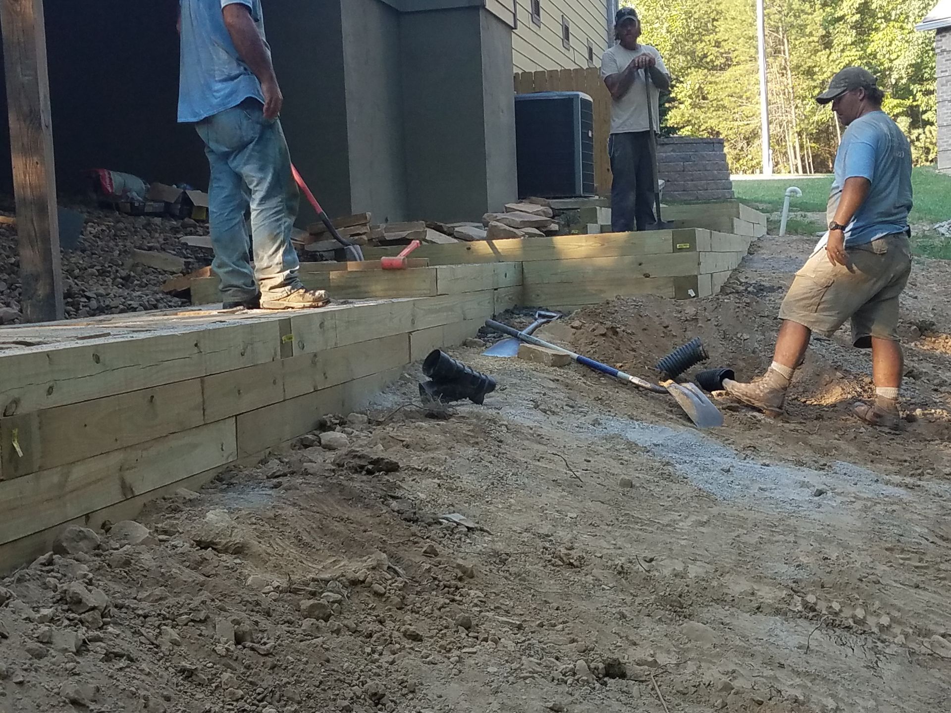 A group of men are working on a lawn project.