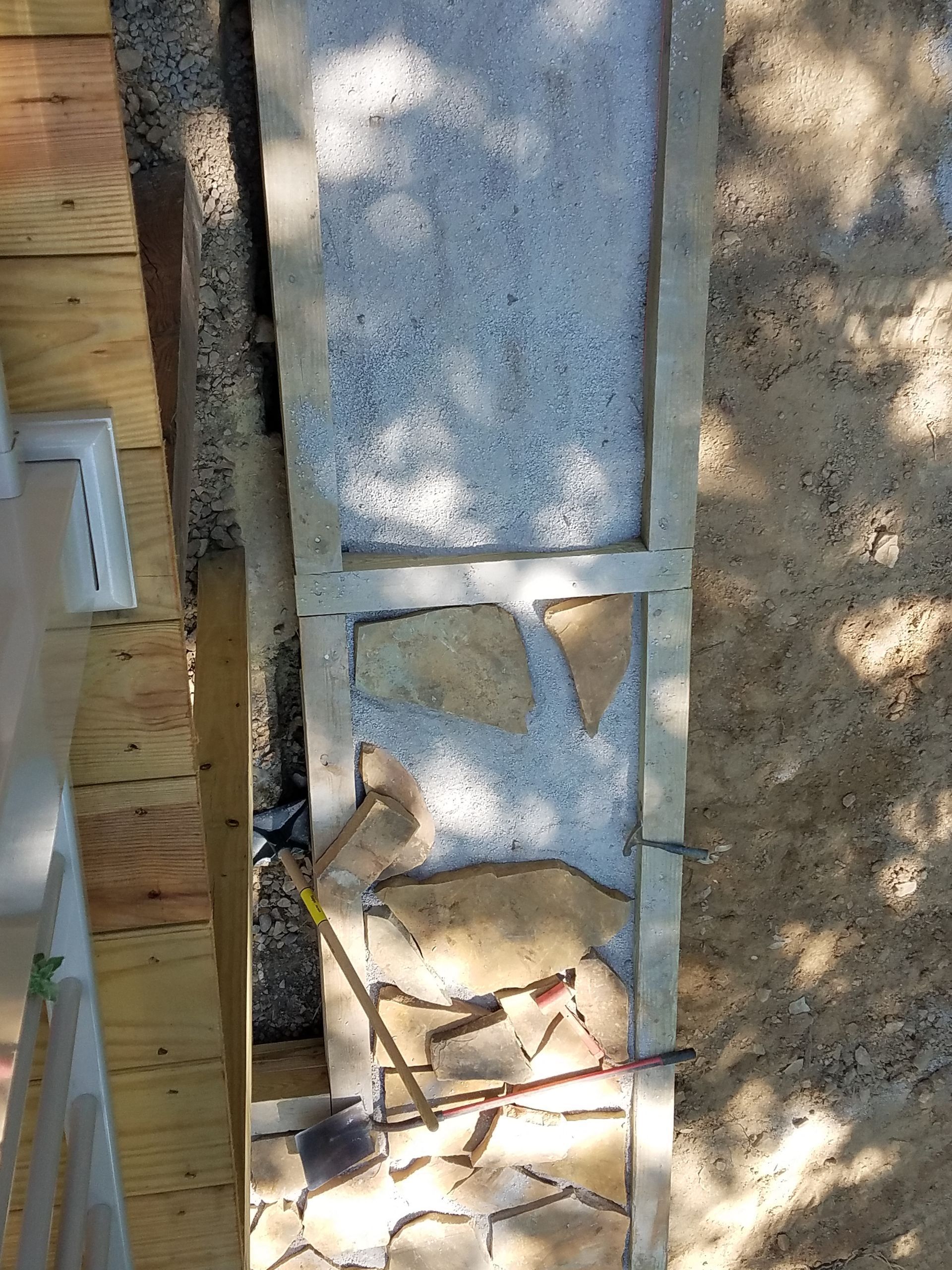 An aerial view of a stone wall being built.